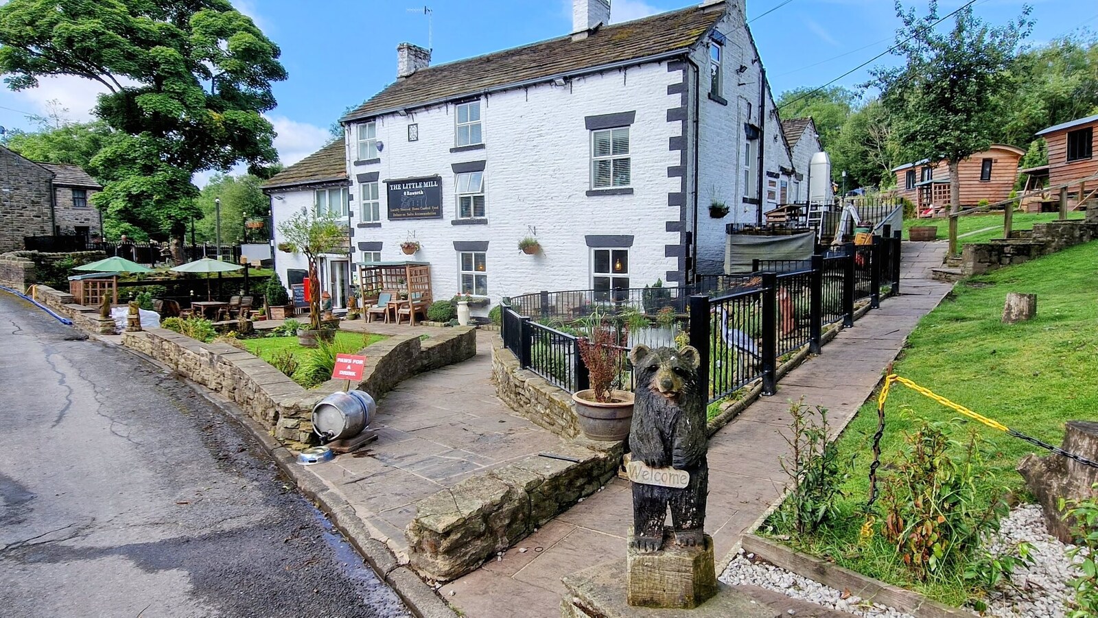 The Little Mill Inn's whitewashed exterior with the carved welcome bear, Rowarth